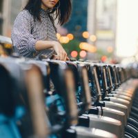 girl renting a city bike from a bike stand in chicago